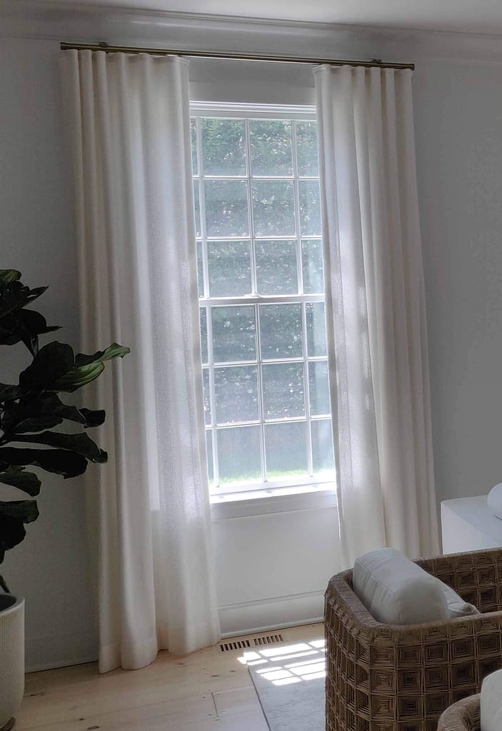 White curtains in a bright, minimalist room.
