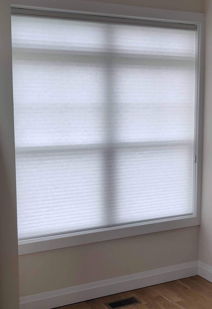 Modern room with a large window shade.