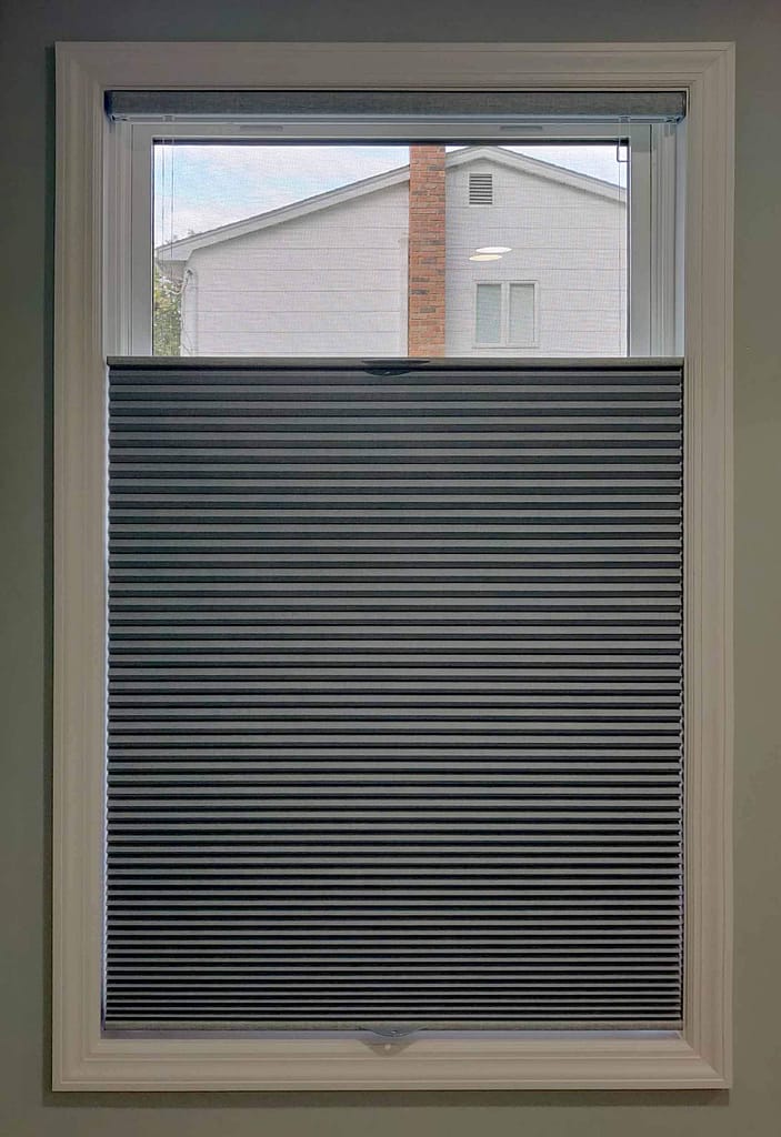 Partially closed window blinds in bright room